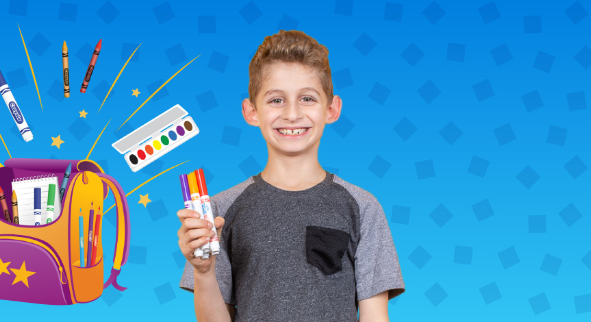 Boy holding crayola markers. There is a school bag in the background