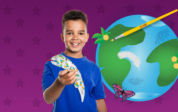 Boy holding a Crayola Imagine Arts Academy take home snake that he competed. An illustration of earth, a butterfly and a pain